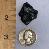 silver sikhote alin meteorite next to a ruler and US quarter for scale