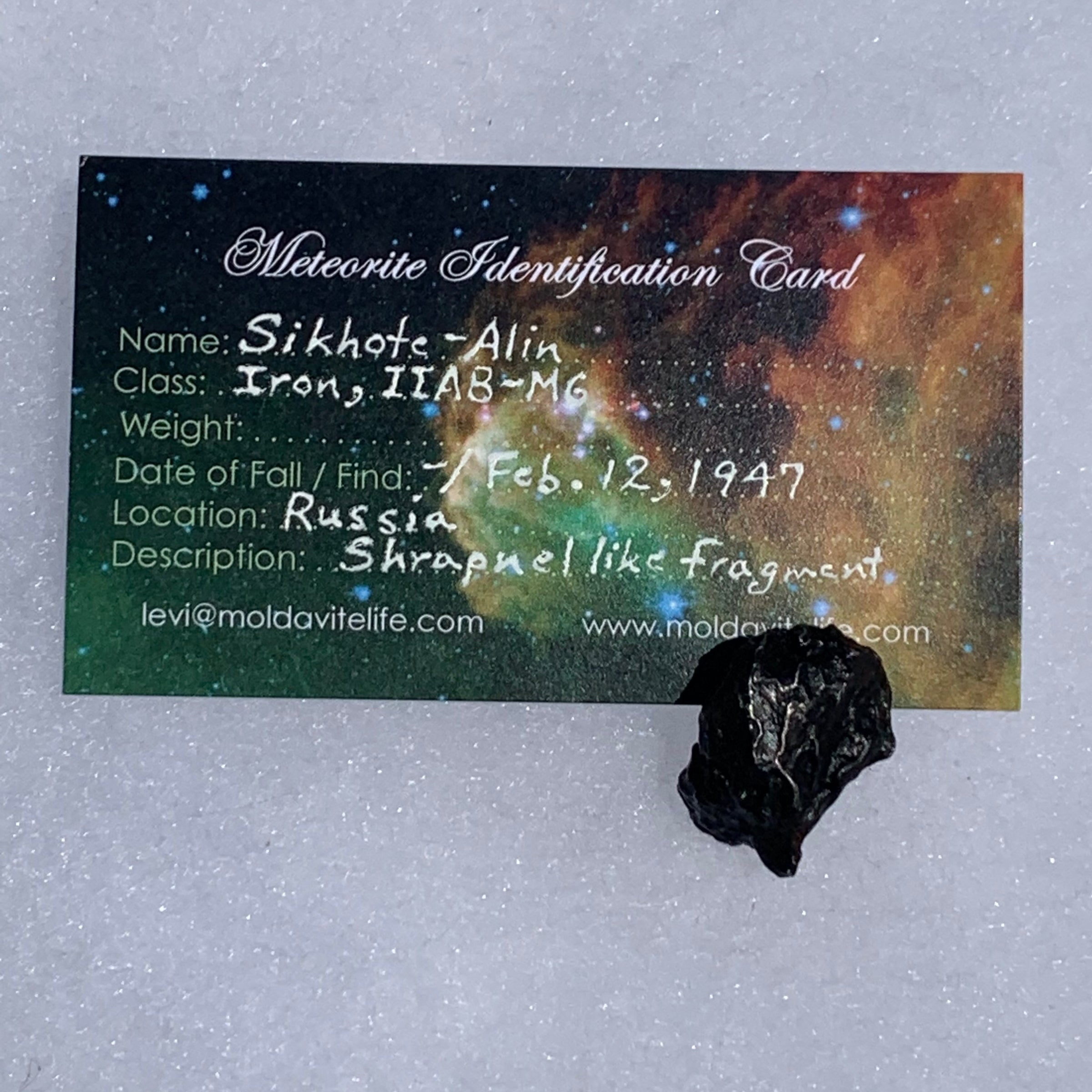 silver sikhote alin meteorite with a moldavite life meteorite identification card