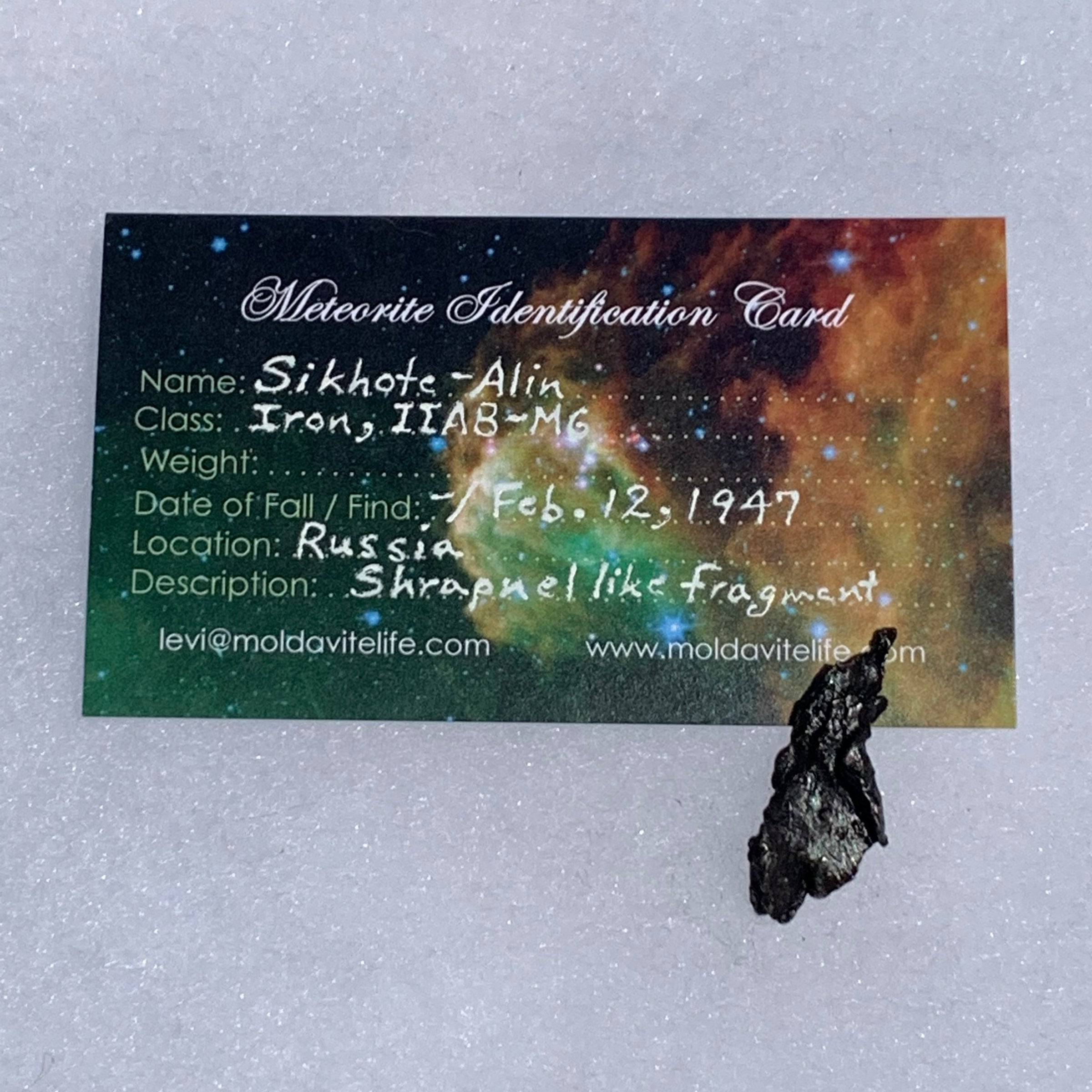 silver sikhote alin meteorite with a moldavite life meteorite identification card