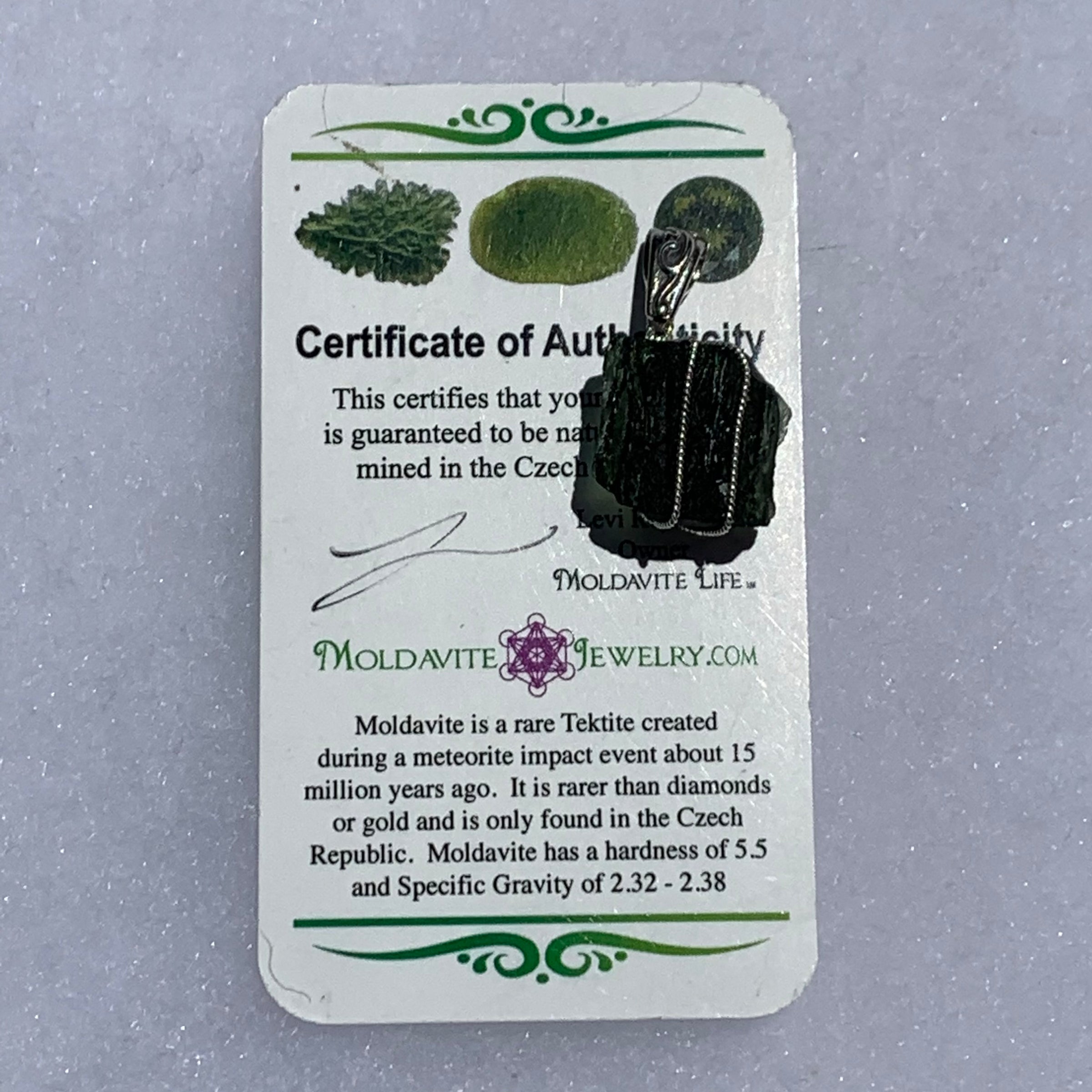 sterling silver wire wrapped raw moldavite tektite pendant with a moldavite life certificate of authenticity