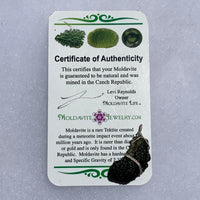 sterling silver wire wrapped raw moldavite tektite pendant with a moldavite life certificate of authenticity