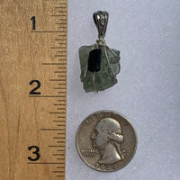 raw moldavite tektite and black tourmaline sterling silver wire wrapped pendant next to a ruler and US quarter for scale