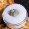 tatahouine meteorite in gem jar sitting on driftwood for display