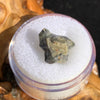 tatahouine meteorite in gem jar sitting on driftwood for display