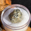 tatahouine meteorite in gem jar sitting on driftwood for display