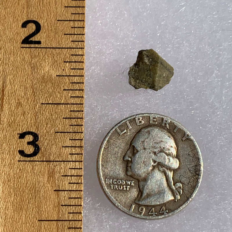 tatahouine meteorite next to a ruler and US quarter for scale