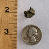 tatahouine meteorite next to a ruler and US quarter for scale