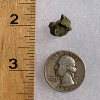 tatahouine meteorite next to a ruler and US quarter for scale