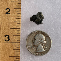 tatahouine meteorite next to a ruler and US quarter for scale