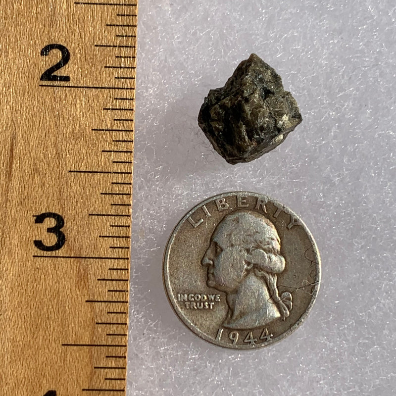 tatahouine meteorite next to a ruler and US quarter for scale